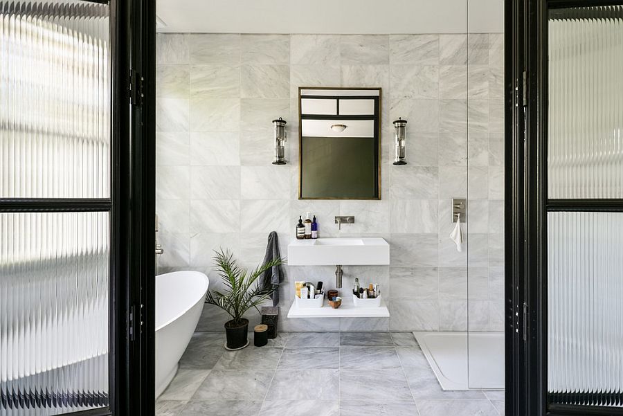 glass shower room with sliding glass door plus silver steel frame and handler placed on the gray wall plus white bath up placed on the white tile flooring  - Ajara Decor
