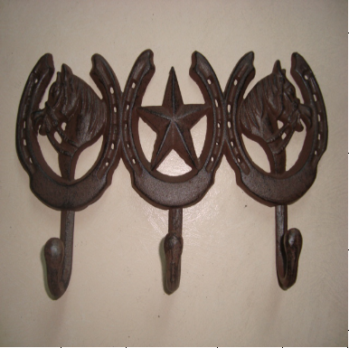 cast iron coat hook with star and two horse heads